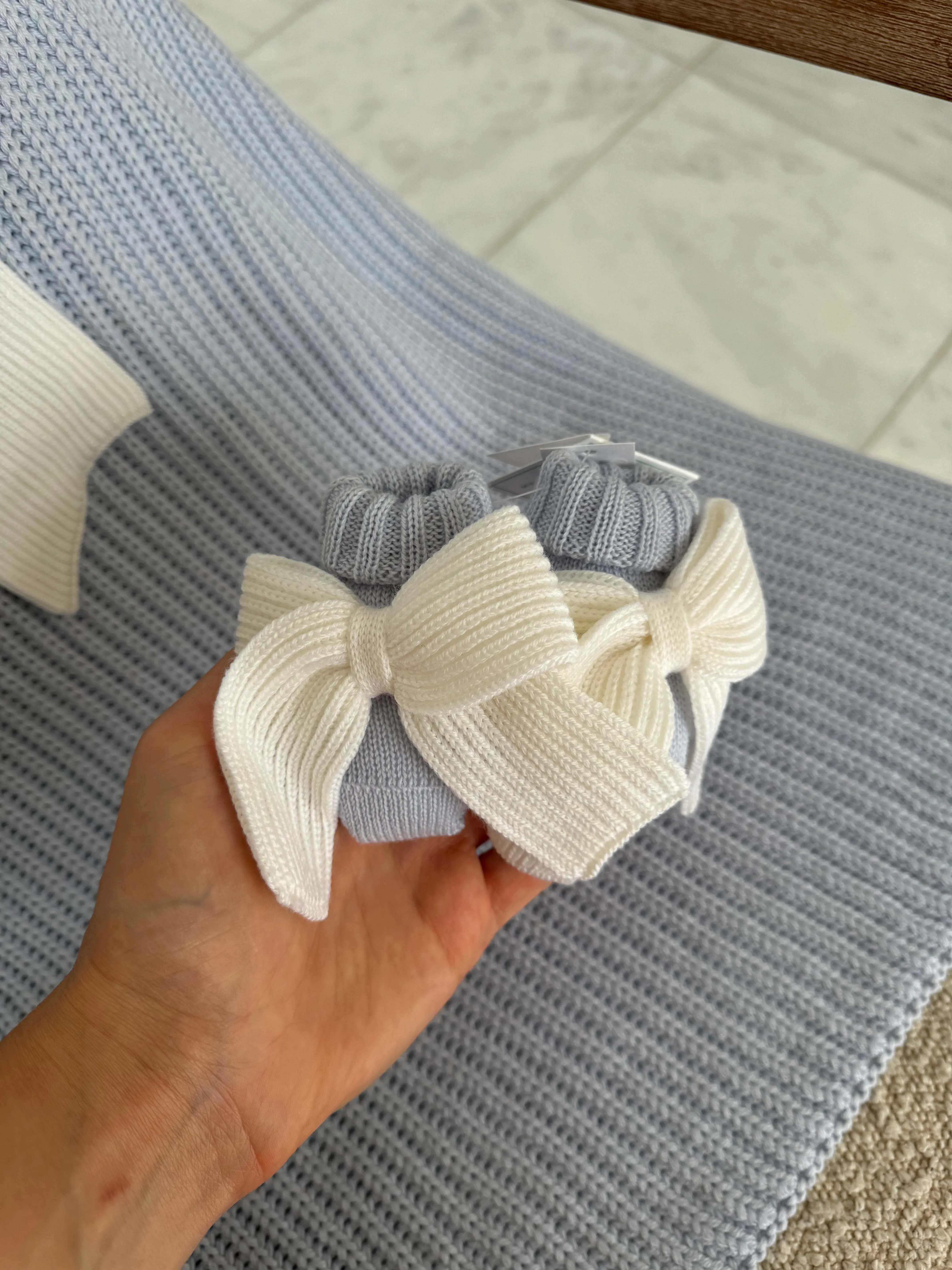 Beautiful knitted Merino Wool Blue Baby Booties with Bow details.
