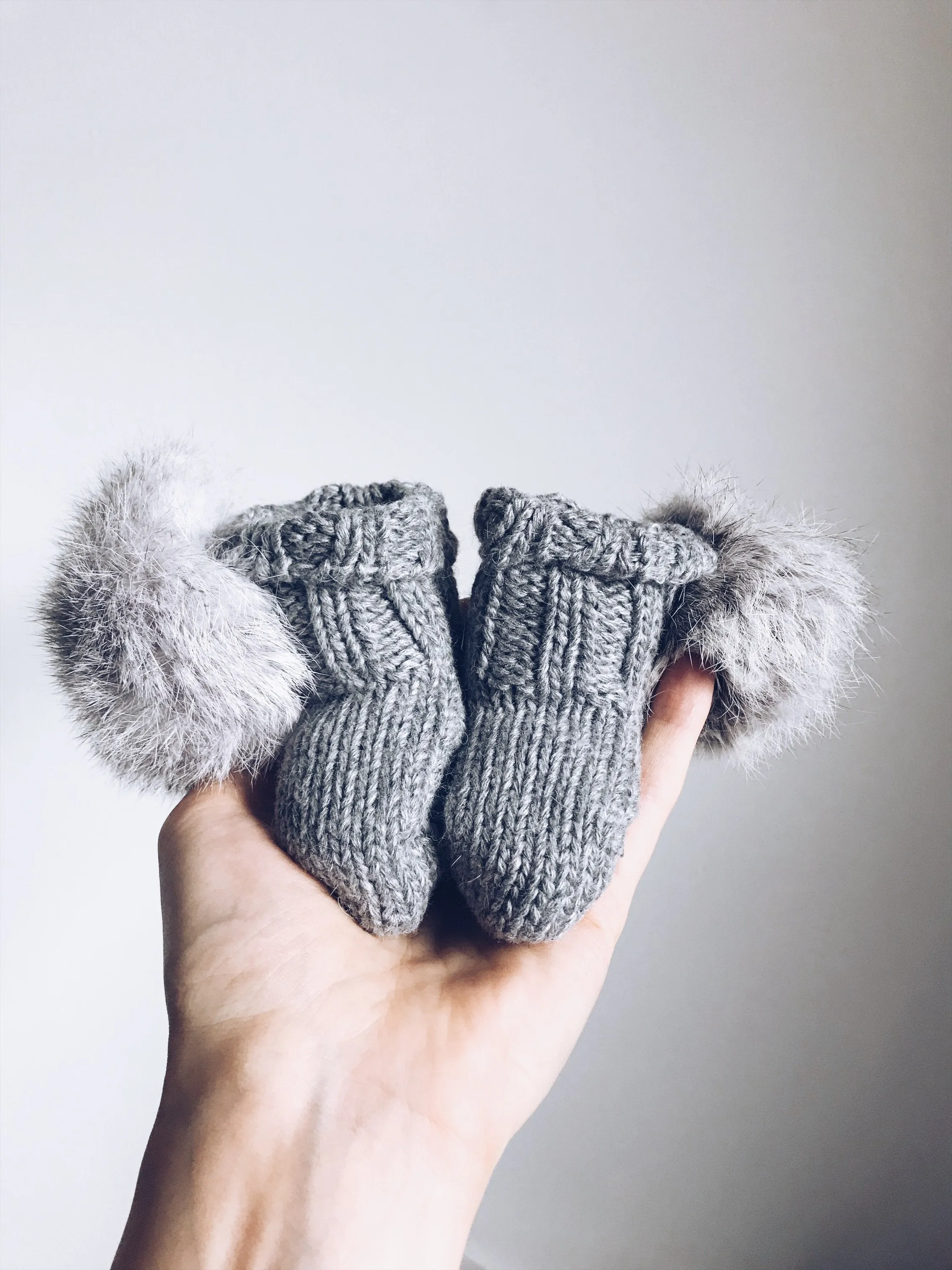 MILOVES Signature Hand Knitted baby booties with rabbit fur pompoms