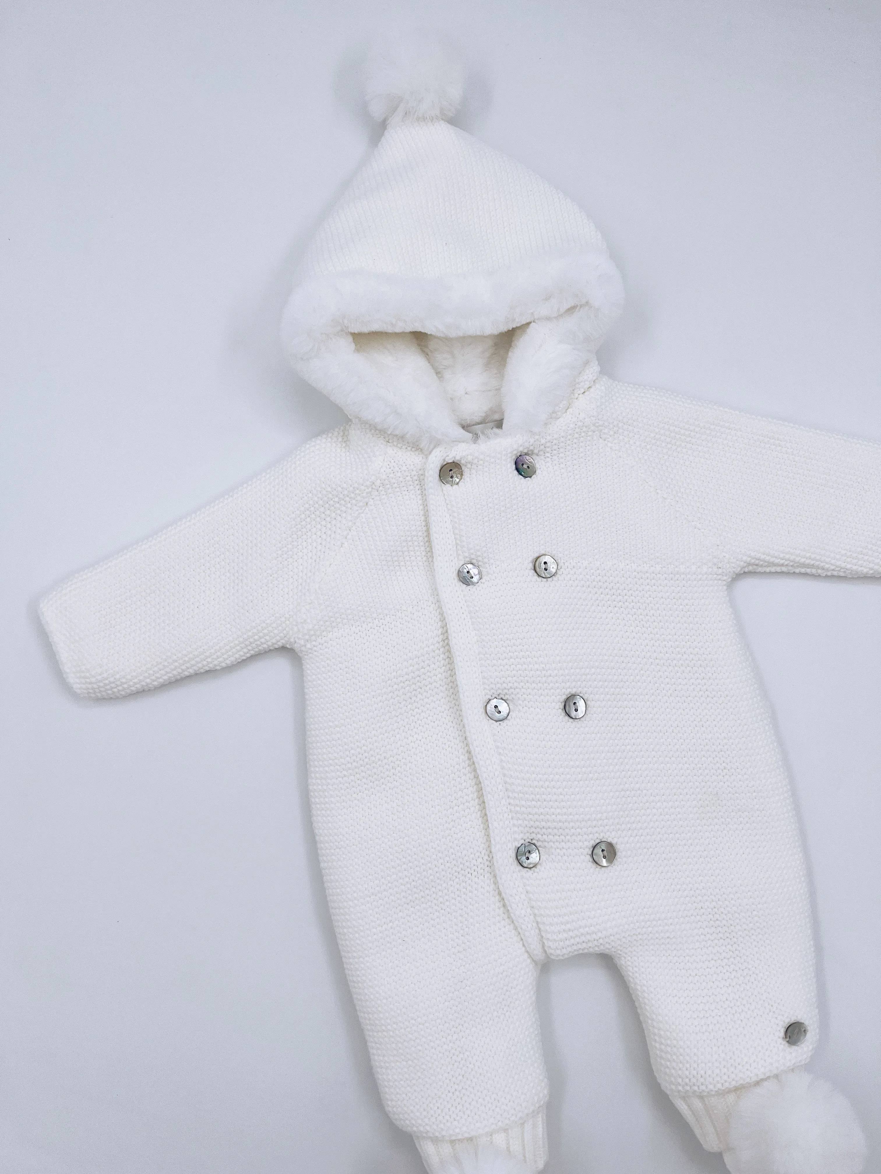 White knitted Baby pramsuit with matching knitted pompom booties.