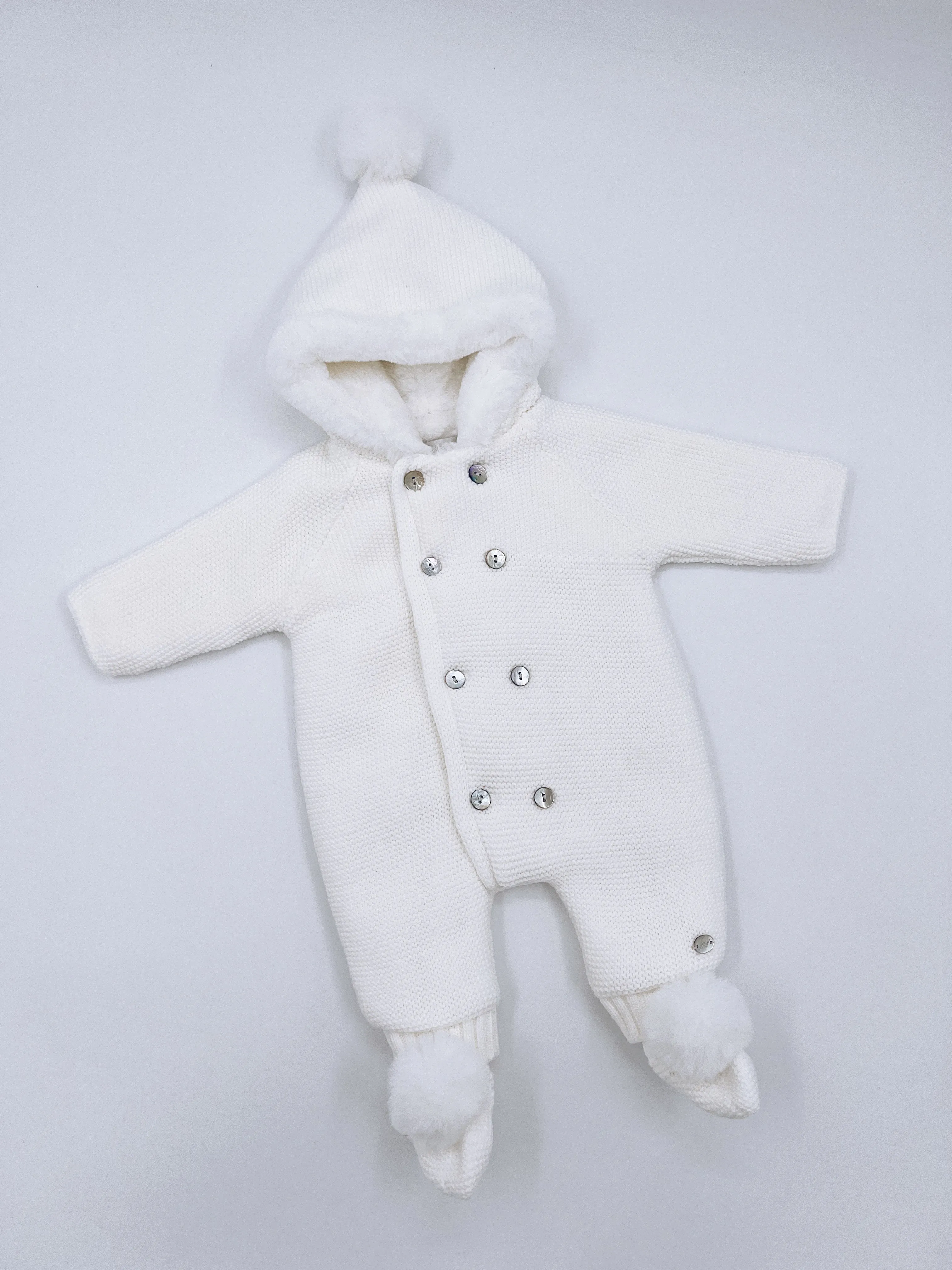 White knitted Baby pramsuit with matching knitted pompom booties.